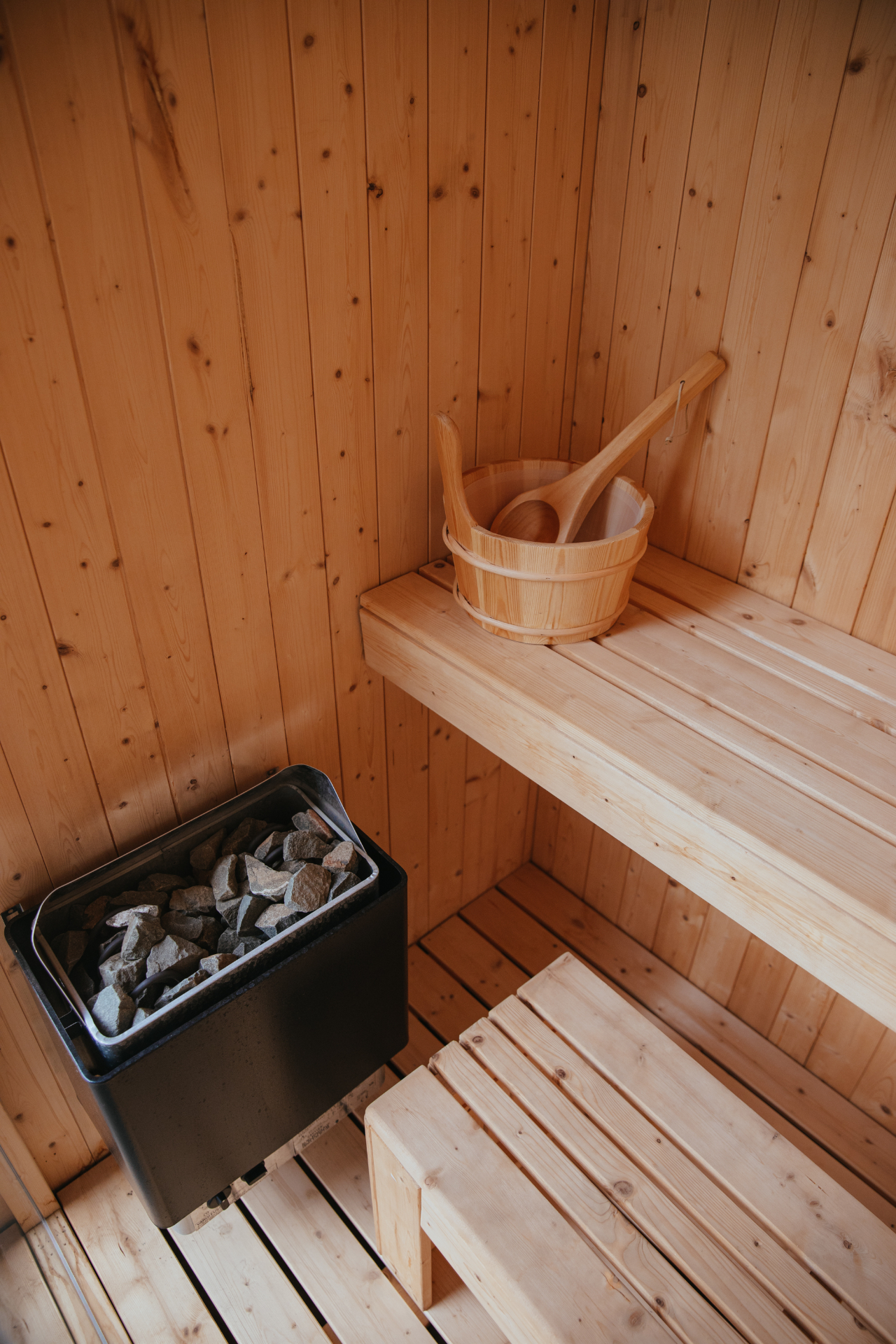 Sauna heater with stones and bucket