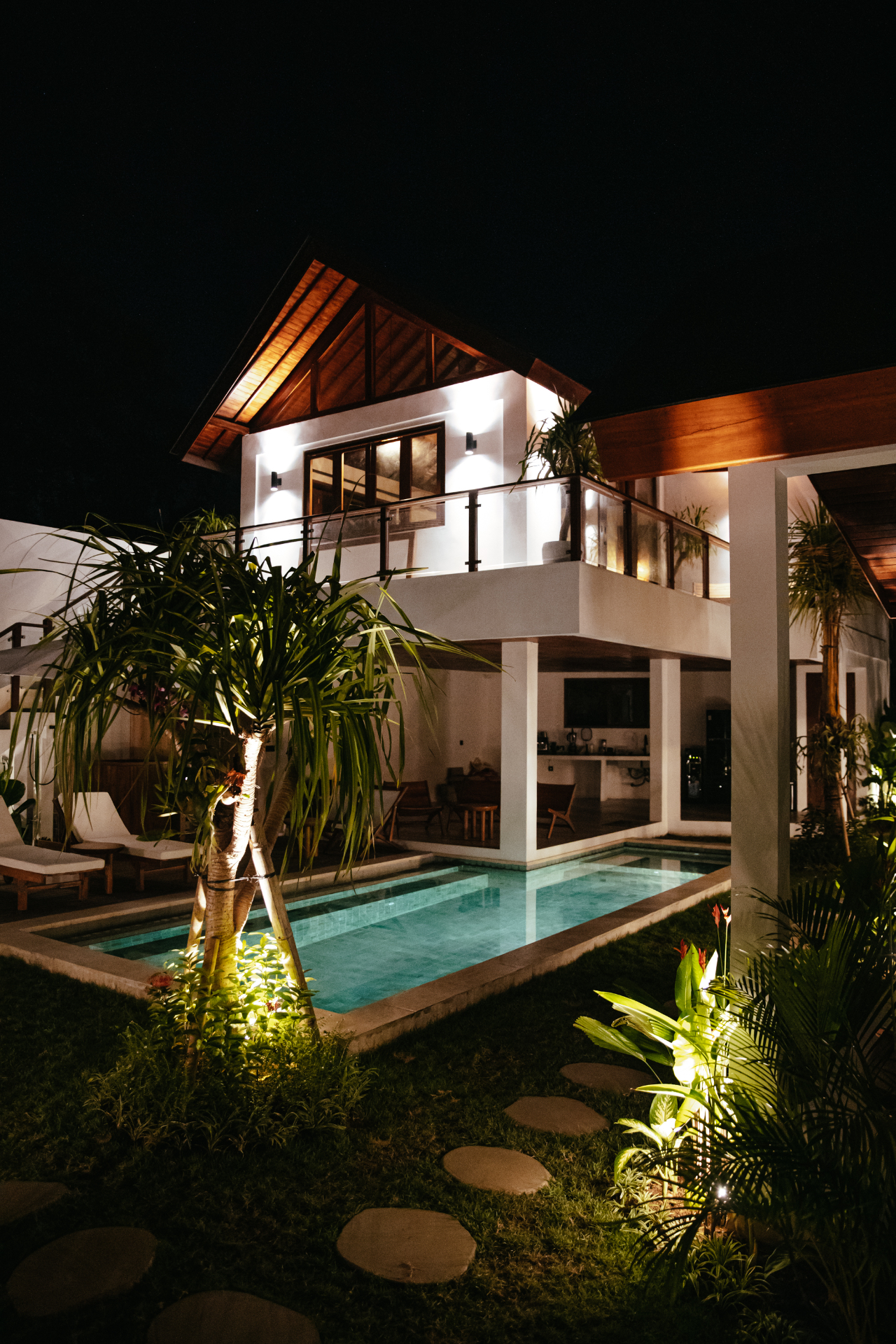 Suara Ombak villa at night with pool