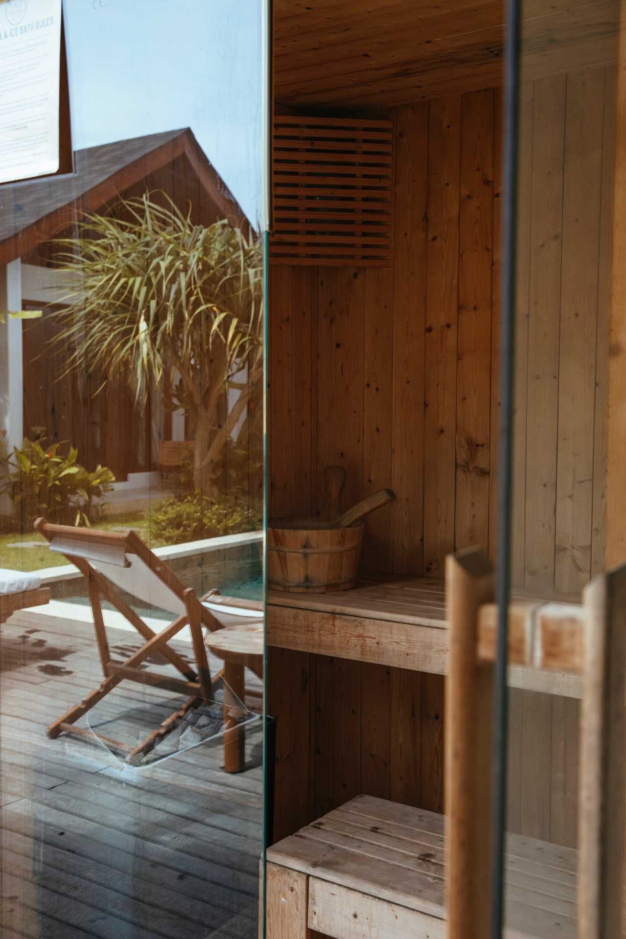 Cedar sauna interior with view to pool